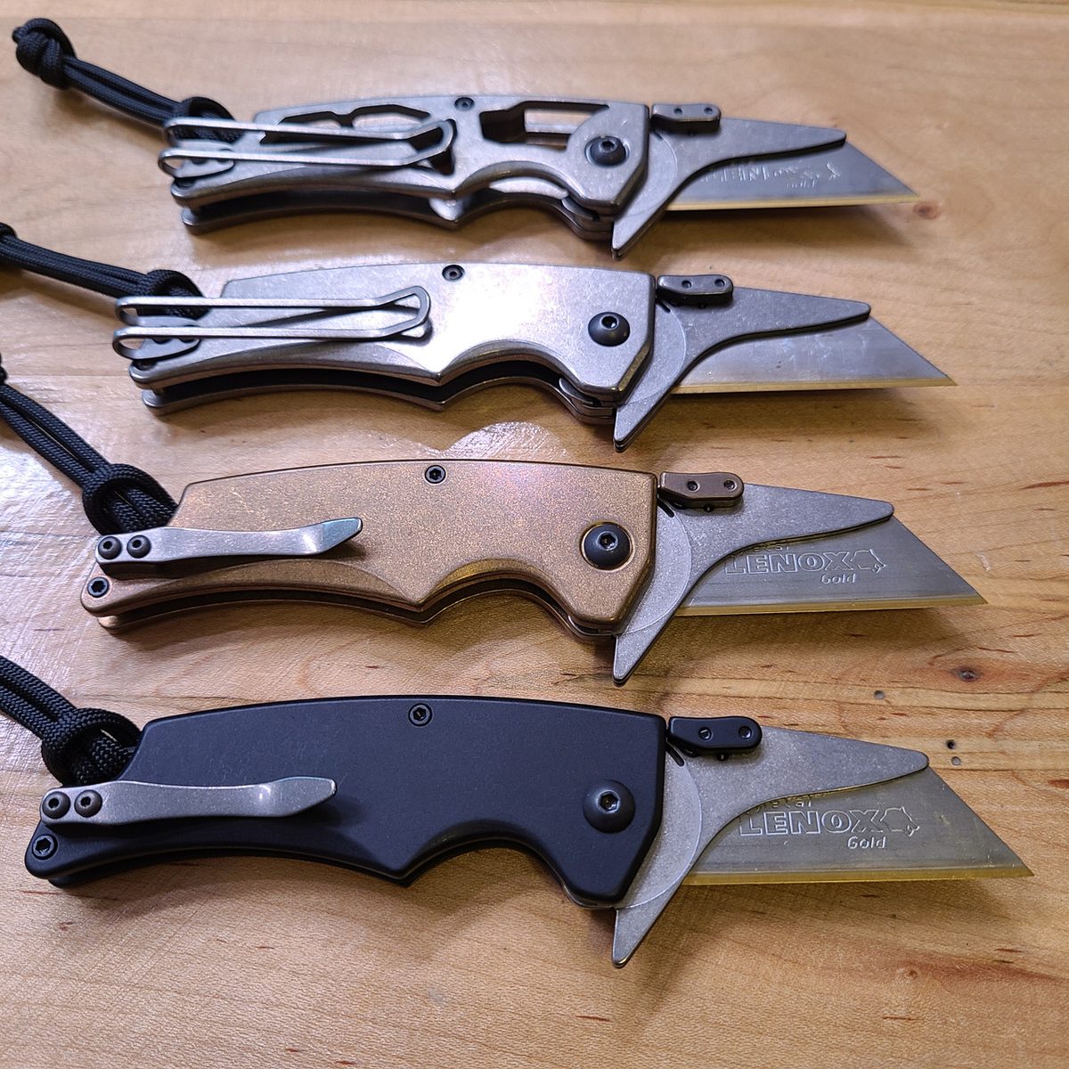 Four Utilizer replaceable-blade knives with different scale finishes
